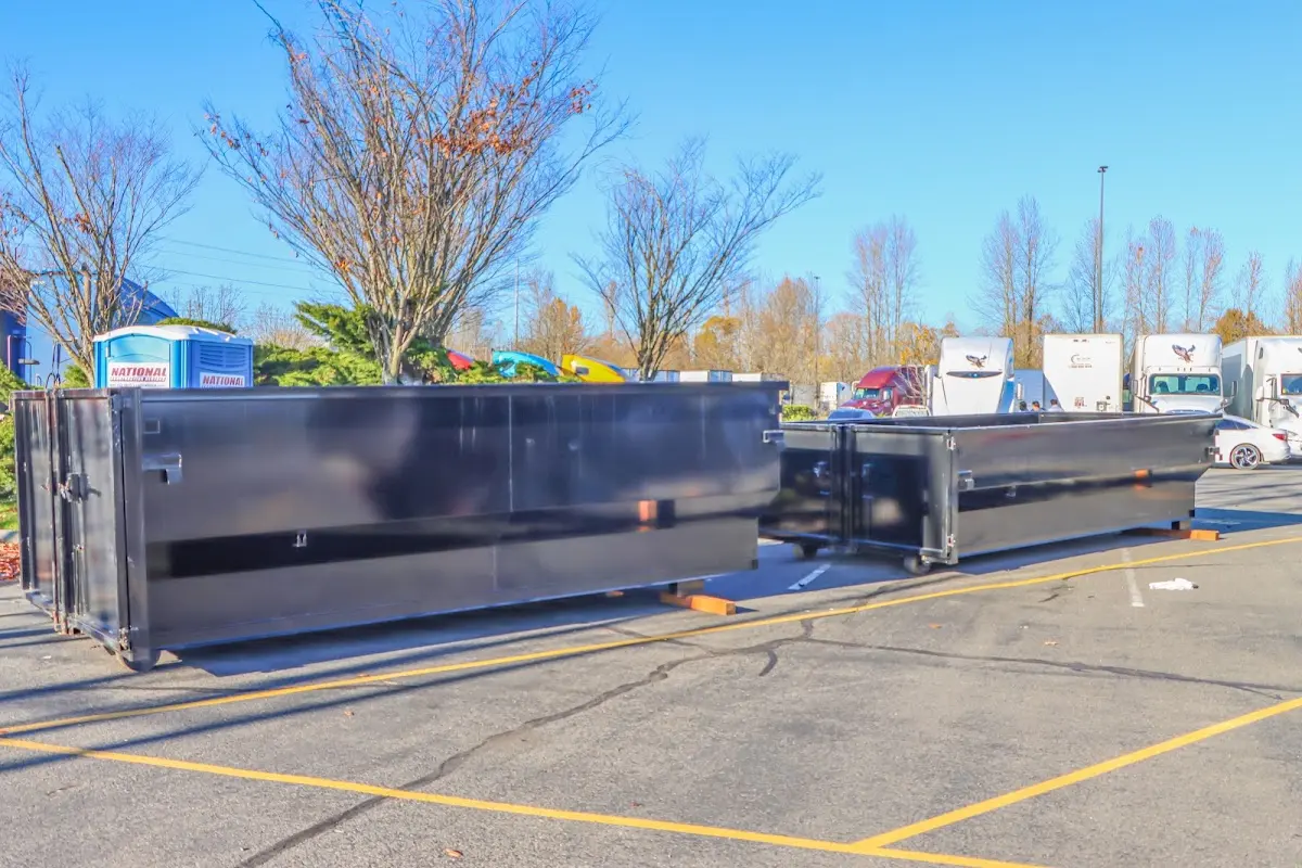 Professional dumpster rental service with roll-off container on residential driveway in Brandermill